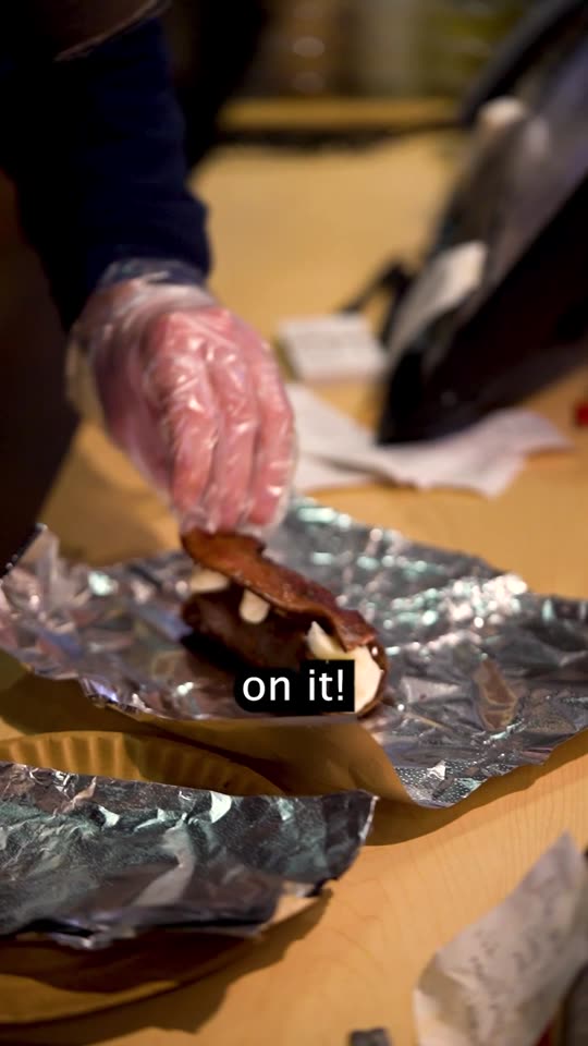 Frame from the pizza video at sixteen seconds, the finished dessert held in hand
